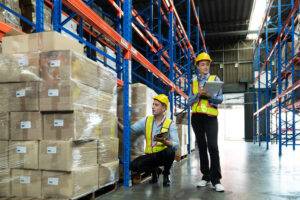 Warehouse workers verifying inventory for a business sale with cycle count process